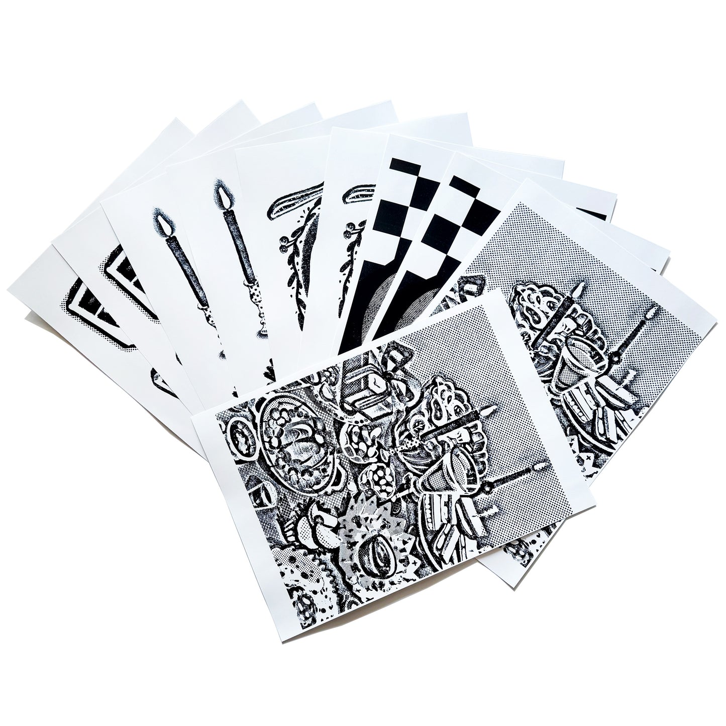 A spread out image of the A4 sized image transfer sheets on the table, showing snippets of the patterns inside.
