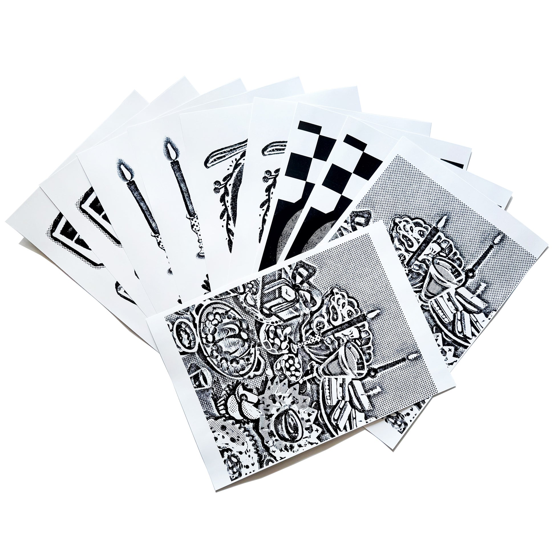 A spread out image of the A4 sized image transfer sheets on the table, showing snippets of the patterns inside.