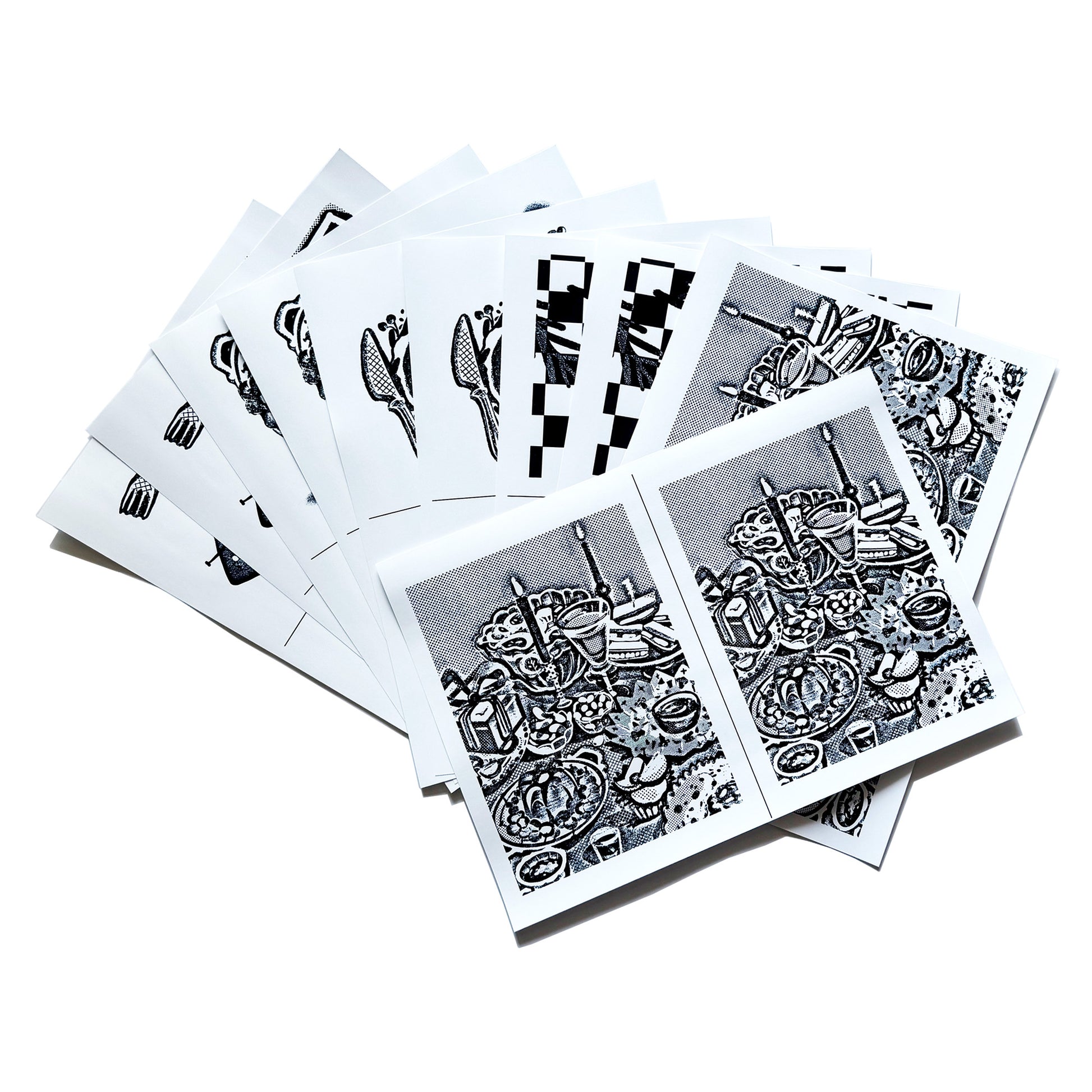 A spread out image of the A5-sized image transfer sheets on the table, showing snippets of the patterns inside.